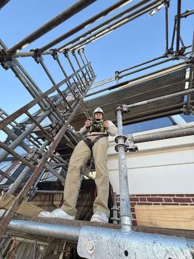 Camera operator standing on production scaffolding