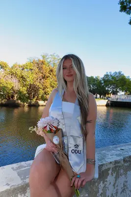 Graduation portrait — ODU waterfront with bouquet