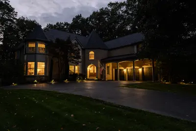 Twilight real estate photo — front exterior with lit windows